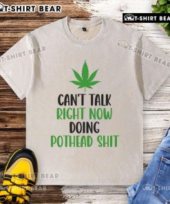 Washed cannabis-themed t-shirt with 'Top Can't Talk Right Now, Doing Pothead Shit' printed in bold lettering.