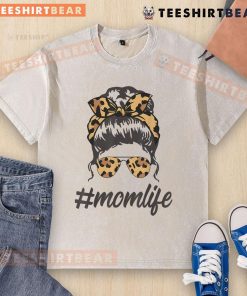 Stylish mom in a washed T-shirt and leopard pattern shades, rocking a cool messy bun, embodying top-classy mom life.