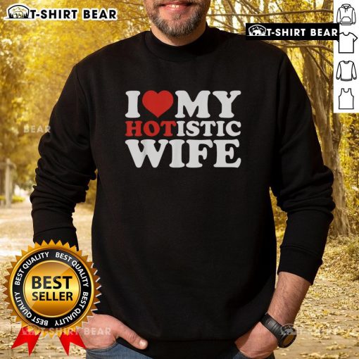Top I Love My Hotistic Wife Sweatshirt displayed on a hanger, showcasing its stylish design and vibrant colors.