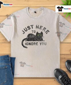Alt Text: Cute cat on a washed t-shirt with the phrase Just Here To Ignore You, perfect for cat lovers and humorous fashion.