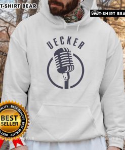 Top microphone Bob Uecker wearing a Milwaukee Brewers hoodie, showcasing team spirit and sports commentary style.