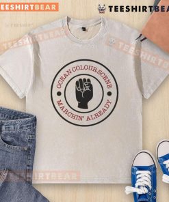 Alt Text: Top Ocean Colour Scene Machine Already Washed T-Shirt displayed on a wooden surface, showcasing vibrant colors and design.