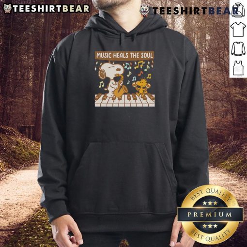 Cozy hoodie featuring Snoopy and Woodstock with the phrase 'Music Heals The Soul' perfect for Peanuts fans.