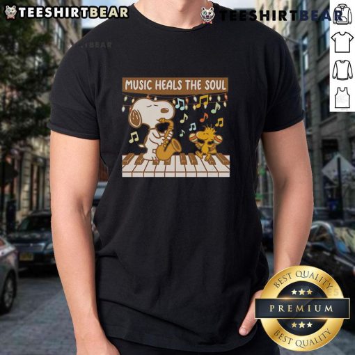 Alt Text: Top Snoopy and Woodstock piano music heals the soul t-shirt featuring vibrant graphics of Snoopy and Woodstock.