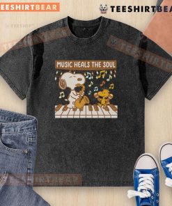 Top Snoopy and Woodstock piano music heals the soul washed t-shirt featuring playful cartoon design and vibrant colors.