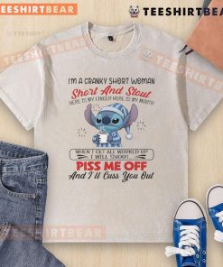 Alt Text: Cranky short woman wearing a I'm A Cranky Short And Stout washed t-shirt, playfully showing her finger and mouth.