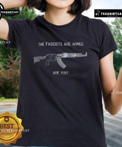 Alt Text: Top-The-Fascists-Are-Armed-Are-You-Ladies-Tee featuring bold text design for women's empowerment against fascism.
