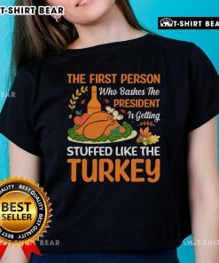 Funny 'Top-The-First-Person-Who-Bashes-The-President' turkey-themed ladies tee, perfect for holiday humor.