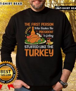 Top-The-First-Person-Who-Bashes-The-President sweatshirt featuring a humorous turkey design for festive celebrations.