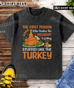 Graphic t-shirt featuring a humorous design about bashing the president, featuring a turkey and playful text.
