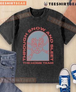 Top The Home Team Through Snow and Sleet washed t-shirt displayed on a rustic wooden background, showcasing its unique design.