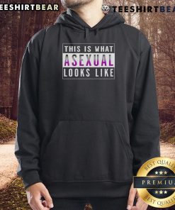 A person wearing a 'Top This Is What Asexual Looks Like' hoodie, showcasing a vibrant design and a confident expression.
