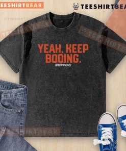 Top Yeah Keep Booing Ram Washed T-Shirt displayed on a hanger, showcasing its unique design and vibrant colors.