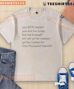 Alt Text: Top You Kick Miette You Kick Her Body Like The Football washed t-shirt featuring a playful football graphic design.