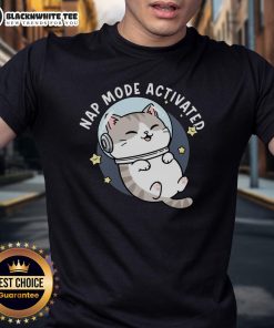 Cute cat napping in zero-gravity position on a 'Nap Mode Activated' T-shirt, perfect for cat lovers and comfy sleepwear.