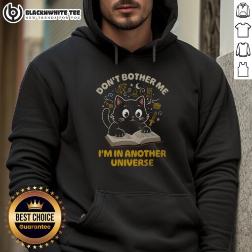 Cute cat in a 'Don't Bother Me, I'm in Another Universe' hoodie, showcasing fun pet fashion for cat lovers.