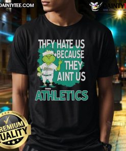 Awesome Athletics Grinch Christmas T-Shirt featuring 'They Hate Us Ain't Us' design for festive sports fans.