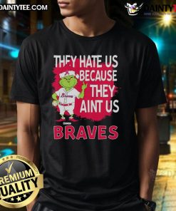 Alt Text: Awesome Atlanta Braves Grinch Christmas T-Shirt featuring 'They Hate Us Ain't Us' design, perfect for holiday cheer.