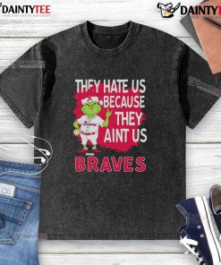 Alt Text: Awesome Atlanta Braves Grinch Christmas t-shirt featuring 'They Hate Us Ain't Us' design for fans celebrating the holidays.