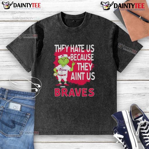 Alt Text: Awesome Atlanta Braves Grinch Christmas t-shirt featuring 'They Hate Us Ain't Us' design for fans celebrating the holidays.