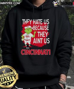 Alt Text: Awesome Cincinnati Reds Grinch Christmas hoodie with 'They Hate Us Ain't Us' design, perfect for holiday fans.