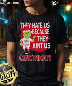 Awesome Cincinnati Reds Grinch Christmas T-Shirt featuring 'They Hate Us Ain't Us' design for festive baseball fans.