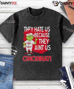 Awesome Cincinnati Reds Grinch Christmas T-shirt featuring 'They Hate Us Ain't Us' slogan in festive design.