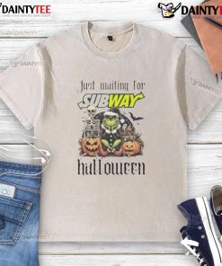 Alt Text: Awesome Grinch waiting for subway in Halloween-themed washed t-shirt, perfect for festive holiday style.