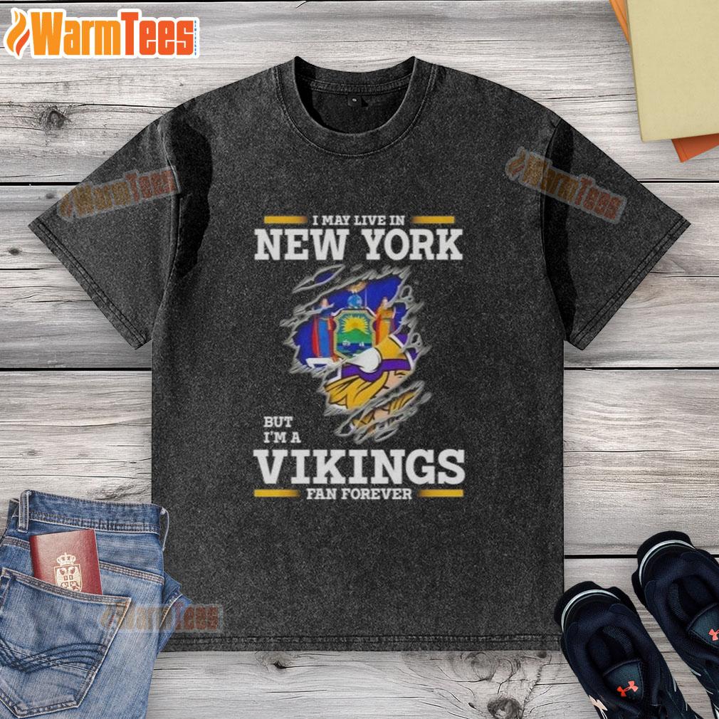 Awesome I May Live In New York But I'm A Minnesota Vikings Fan Forever Washed T-Shirt Awesome I May Live In New York But I'm A Minnesota Vikings Fan Forever washed t-shirt displayed on a hanger.