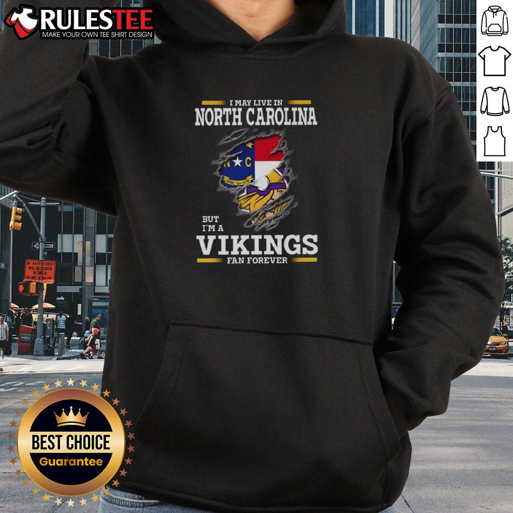 Awesome I May Live In North Carolina But I'm A Minnesota Vikings Fan Forever Hoodie Awesome hoodie for Minnesota Vikings fans living in North Carolina, featuring bold team colors and logo design.