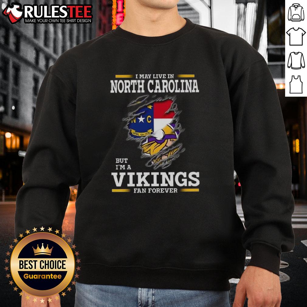 Awesome I May Live In North Carolina But I'm A Minnesota Vikings Fan Forever Sweatshirt Awesome sweatshirt for Minnesota Vikings fans living in North Carolina, showcasing team pride and style.