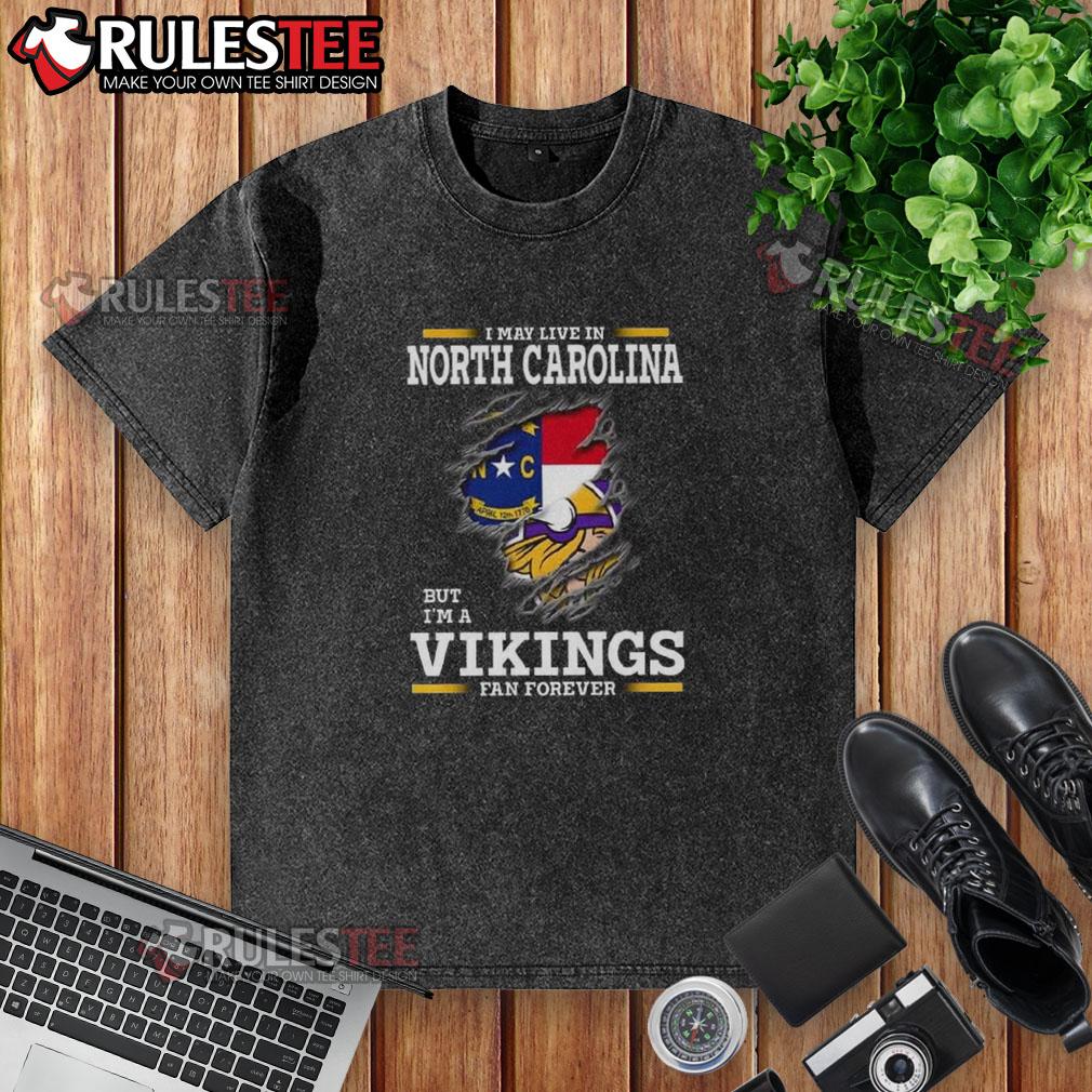 Awesome I May Live In North Carolina But I'm A Minnesota Vikings Fan Forever Washed T-Shirt Alt Text: Minnesota Vikings fan wearing a washed t-shirt, showcasing pride in their team while living in North Carolina.