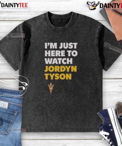 Alt Text: Awesome Jordyn Tyson wearing 'I'm Just Here To Watch' washed t-shirt, showcasing casual style and trendy fashion.