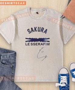 Alt Text: Awesome Los Angeles Dodgers Sakura Le Sserafim Signature Washed T-Shirt displayed on a hanger against a vibrant backdrop.