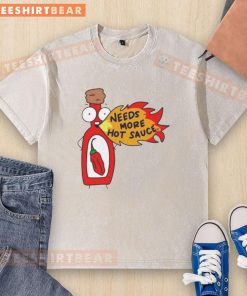 Funny cartoon on a washed t-shirt featuring spicy food and the phrase 'Awesome Needs More Hot Sauce' for chili lovers.