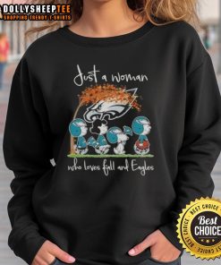 Woman wearing 'Awesome Peanuts' sweatshirt, celebrating fall and Philadelphia Eagles football in cozy autumn setting.