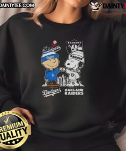 Alt Text: Awesome Snoopy and Charlie Brown sweatshirt featuring Los Angeles Dodgers and Las Vegas Raiders skyline design.