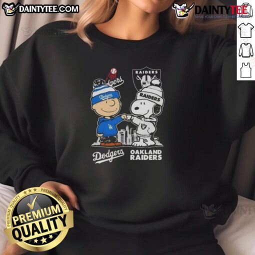Alt Text: Awesome Snoopy and Charlie Brown sweatshirt featuring Los Angeles Dodgers and Las Vegas Raiders skyline design.