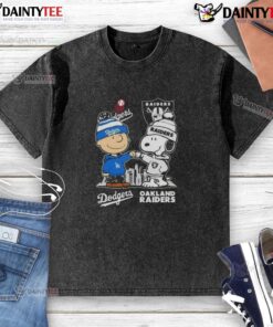 Alt Text: Awesome Snoopy and Charlie Brown Los Angeles Dodgers x Las Vegas Raiders skyline washed t-shirt design.