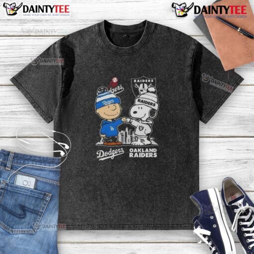 Alt Text: Awesome Snoopy and Charlie Brown Los Angeles Dodgers x Las Vegas Raiders skyline washed t-shirt design.