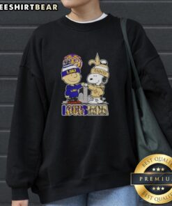 Awesome Snoopy and Charlie Brown LSU Tigers x New Orleans Saints skyline sweatshirt featuring vibrant graphics.