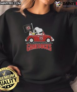 Alt Text: Awesome Snoopy driving a car in a South Carolina Gamecocks football sweatshirt, showcasing team spirit and fun.