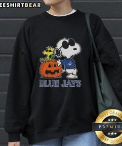 Awesome Snoopy Toronto Blue Jays MLB pumpkin Halloween sweatshirt featuring Peanuts cartoon design for 2025.