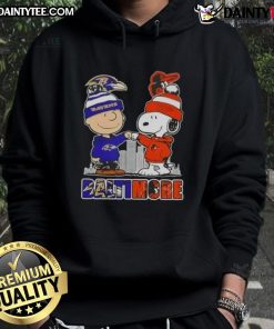 Alt Text: Awesome Snoopy x Charlie Brown hoodie featuring Baltimore Ravens and Orioles skyline design.