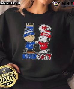 Awesome Snoopy X Charlie Brown Kansas City Sports Royals X Chiefs Skyline Sweatshirt showcasing iconic characters and city skyline.