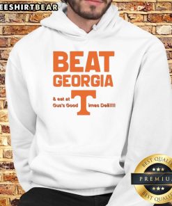 Alt Text: Tennessee Volunteers fans wearing hoodies celebrate victory over Georgia at Guss Good Times Deli.