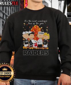 Awesome Peanuts character sweatshirt featuring Las Vegas Raiders design for the holiday season. Perfect for winter wear!