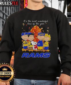 Alt Text: Awesome Peanuts character sweatshirt for Los Angeles Rams, celebrating the holiday season with festive cheer.
