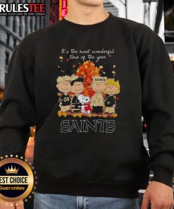Awesome Peanuts character sweatshirt featuring New Orleans Saints theme, perfect for the holiday season.