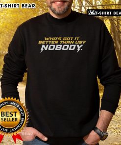 Awesome 'Who's Got It Better Than Us' sweatshirt in a cozy setting, showcasing stylish design and vibrant colors.